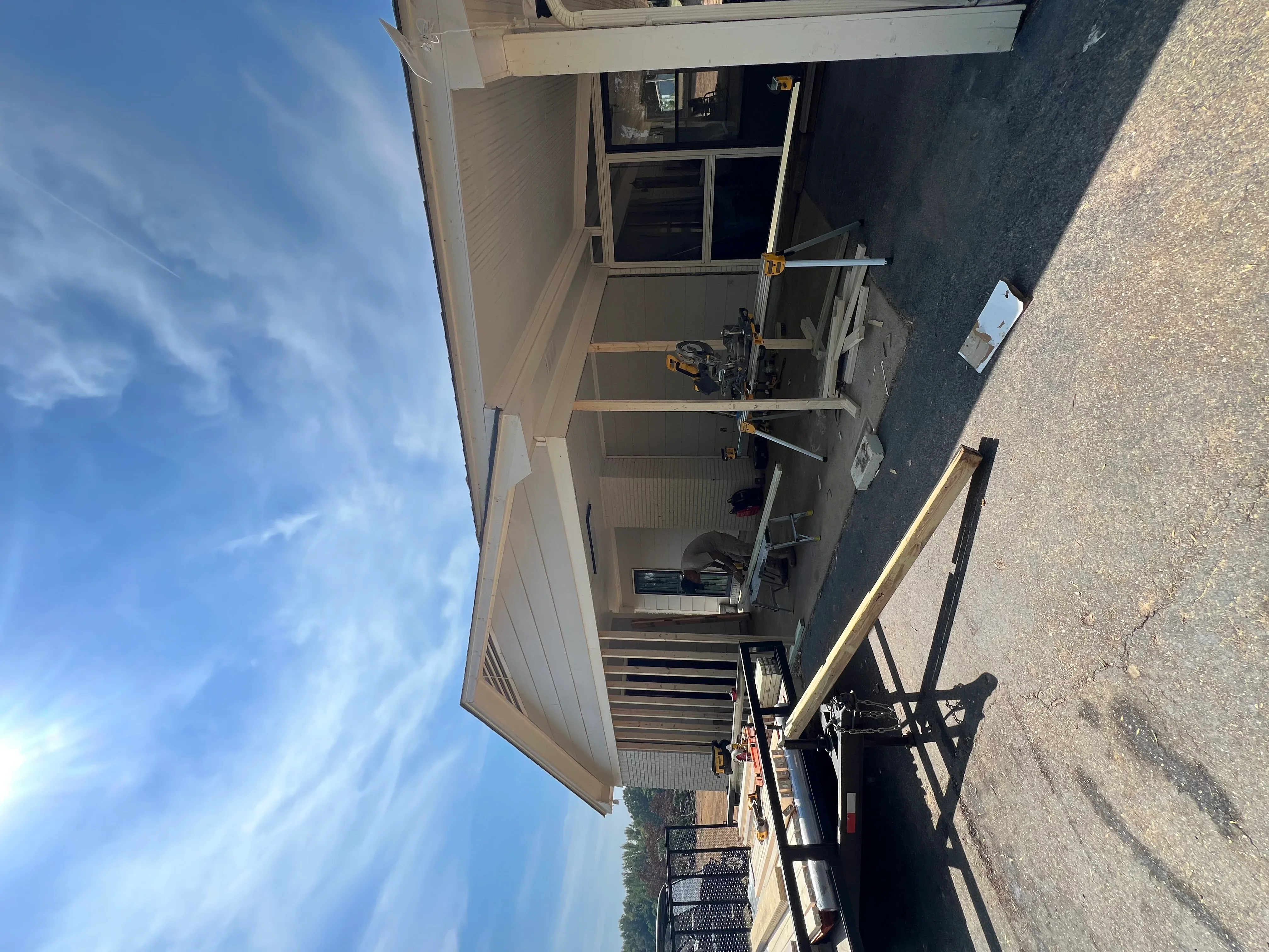 Interior residential framing with drywall installation and window opening in progress